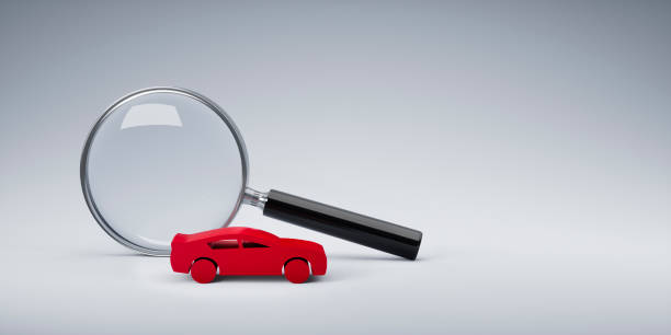 istock Magnifying glass with red toy car 1329190647