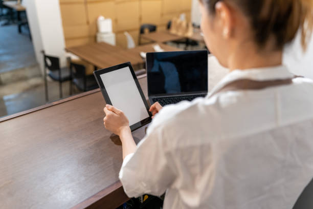 Asian owner checking documents from accountant. Japanese owner checking the document from accountant. Digital tablet in focus. japan restaurant bill stock pictures, royalty-free photos & images