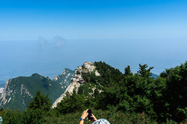 istock China's Huashan, a mountain peak under the blue sky and white clouds, many tourists 1329192169