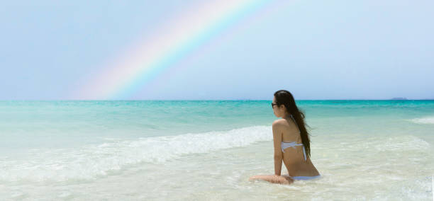istock A woman relaxing on a rainbow beach 1329194391