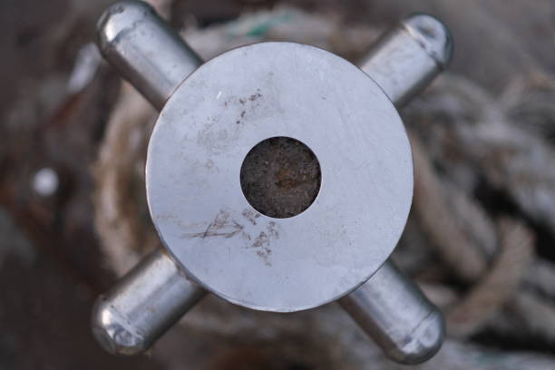 A top of stainless steel mooring rod at sea wharf, with bight of rope on it