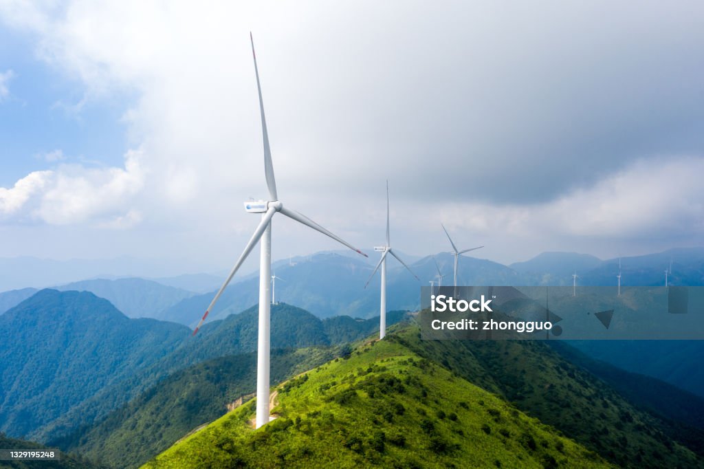 Alpine meadows and wind power Wind Turbine Stock Photo