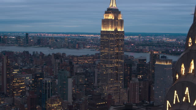 AERIAL: Breathtaking view of the Chrysler and Empire State Building at night.