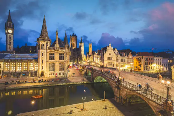 High point of view of Medieval city of Gent in Flanders with Saint Nicholas Church and Gent Town Hall, Belgium. Sunset cityscape of Gent. High quality photo