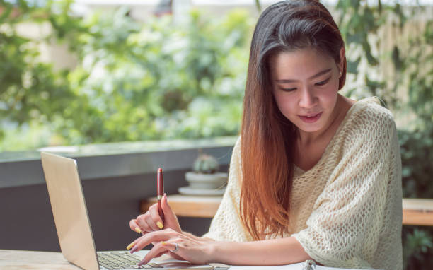 istock Asian woman is working at home 1329202154