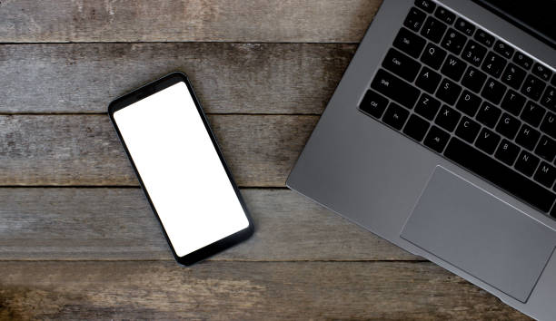 istock Smart phone with empty screen on wooden desk. Top view Communicator Technology On Wood Table Top View 1329202677