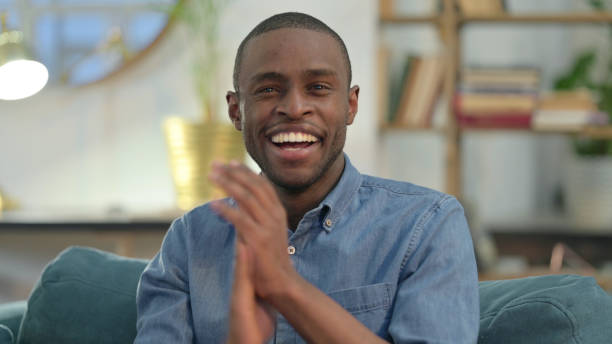 istock Positive Young African Man Clapping at Home 1329204639