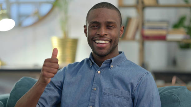 istock Young African Man with Thumbs Up at Home 1329204685