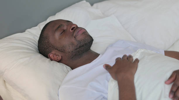 istock Peaceful Young African Man Sleeping in Bed 1329204862