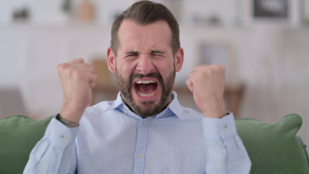 istock Angry Young Man Shouting Loud at Home 1329204878