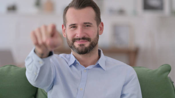 istock Portrait of Beard Young Man Pointing at Camera 1329204899