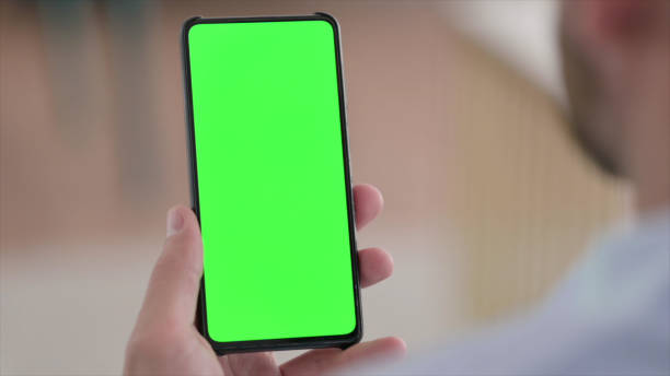 istock Hand Holding Green Chroma Screen Smartphone 1329204901