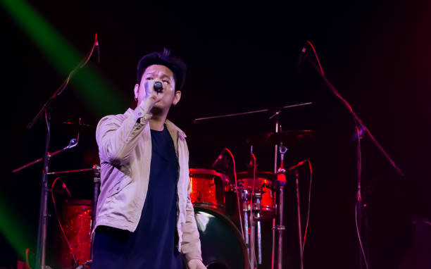 istock Asian male singer showing his performance on stage 1329204968
