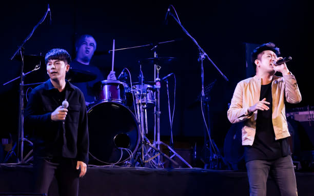 istock Asian male singer showing his performance on stage 1329204987