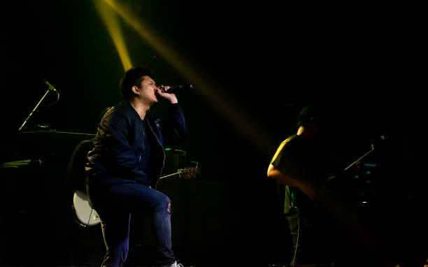 istock Asian male singer showing his performance on stage 1329205529