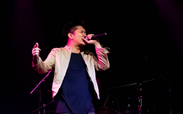 istock Asian male singer showing his performance on stage 1329205543