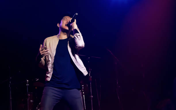 istock Asian male singer showing his performance on stage 1329205551