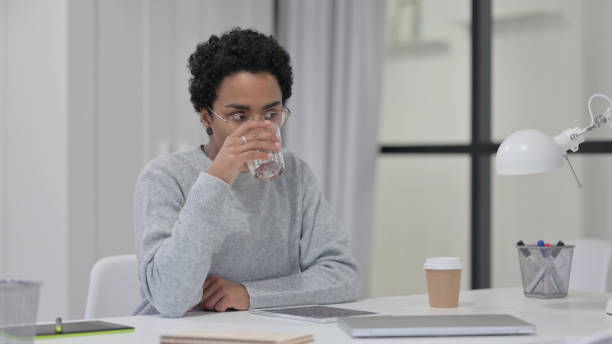 istock African Woman Drinking Water at Work 1329206117