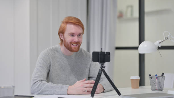 istock Video Recording on Smartphone by Young Beard Redhead Man 1329206165