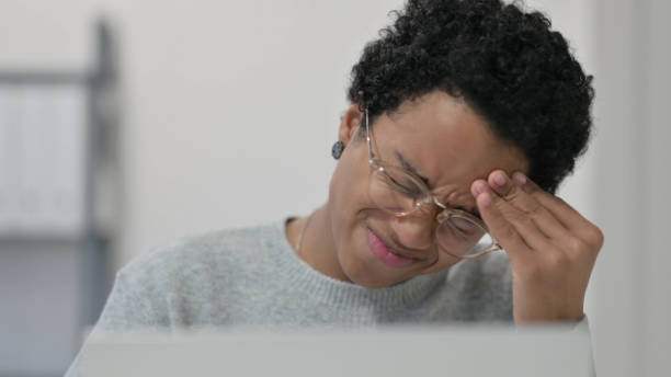 istock Close up of African Woman having Headache while using Laptop 1329206182