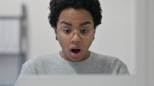 istock Close up of African Woman having Loss while using Laptop 1329206268