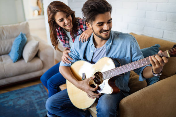 istock Hipster couple having fun with play music together. 1329207184
