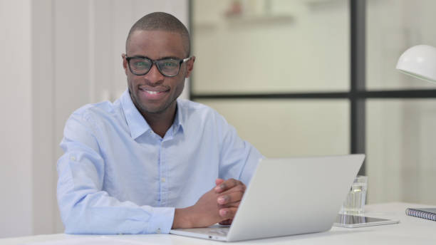 istock African Man with Laptop Shaking Head as Yes Gesture 1329207207