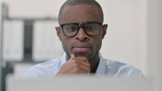 istock Close Up of Pensive African Man Using Laptop, Thinking 1329207261