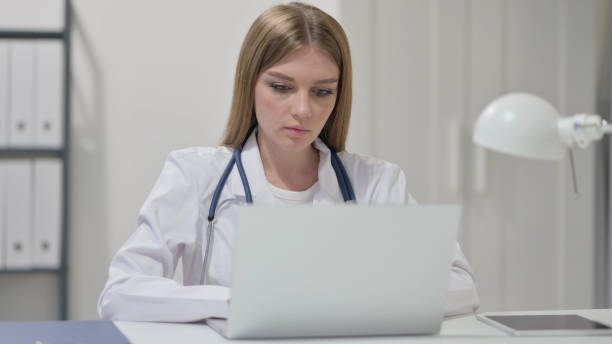 istock Female Doctor Working on Laptop in clinic 1329207321