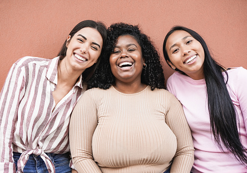 Happy latin women with different skin color looking in camera - Concept of multiracial people, friendship and happiness