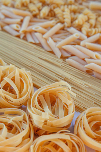 istock 5 different pasta varieties, spaghetti, macaroni, noodles 1329208577