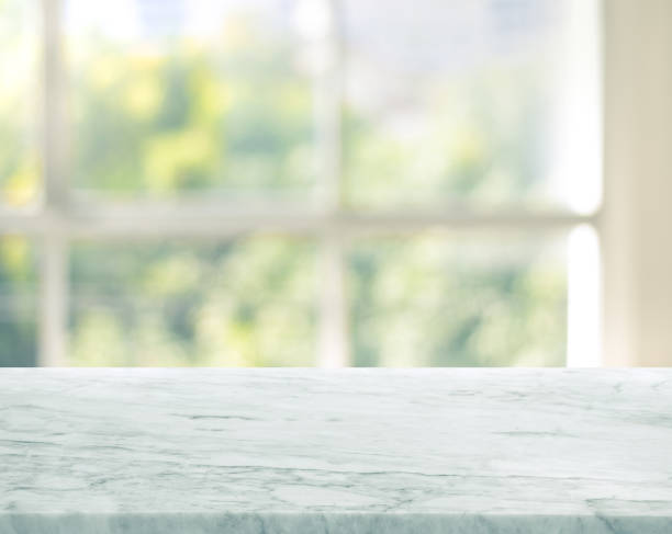 istock Selective focus.Marble table top on blur window glass background. 1329208579