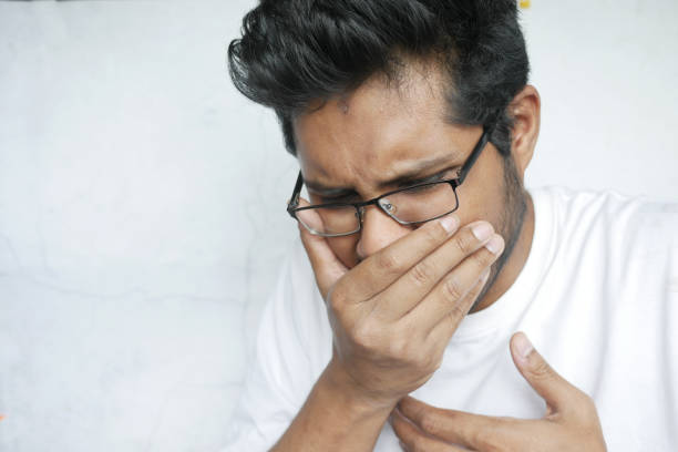 istock young sick man coughing and sneezes 1329208909