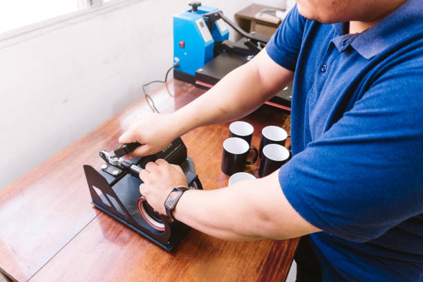 istock Hands of an unrecognizable man holding a sublimation machine designs on a mug. graphic design concept. 1329209944