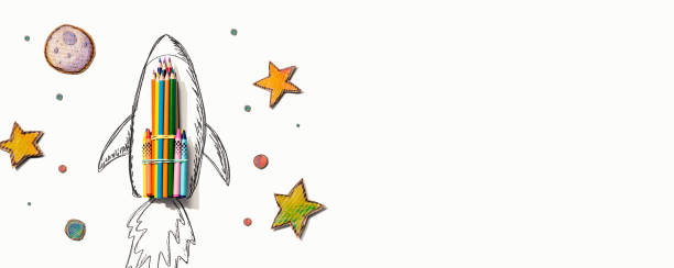 istock Back to school theme with a rocket and colored pencils 1329210019