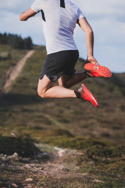 istock Happy trail runner jumping on mountains with copy-space. 1329210311