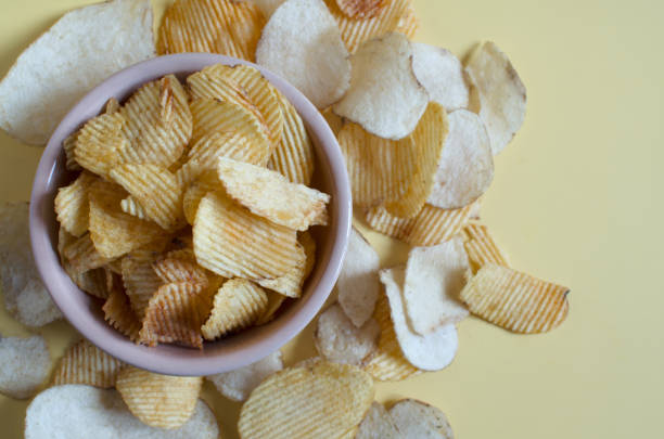 istock Fluted potato chips close-up on a colored background. Kopi space potato chips 1329213675