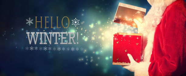 istock Hello winter message with Santa opening a gift box 1329214049