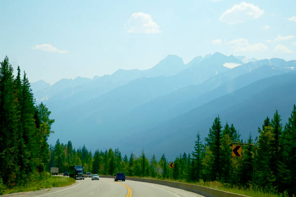 Highland meadows, mountains and roads in cloudy weather