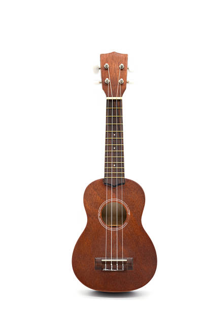 istock Ukulele guitar isolated on white. Brown acoustic guitar 1329216874