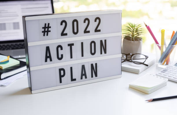 2022 action plan text on light box on desk table in office - 2022 stok fotoğraflar ve resimler