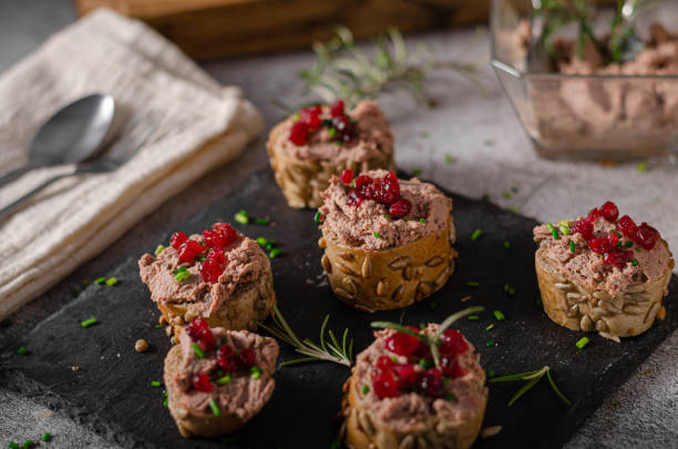 Homemade pate on heathy bread with cranberries Delicious homemade pate with wholegrain pastry and herbs heathy snack stock pictures, royalty-free photos & images