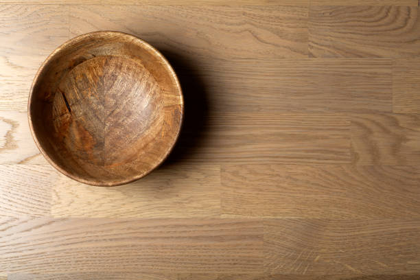 Empty wooden bowl on wood parquet laminate floor