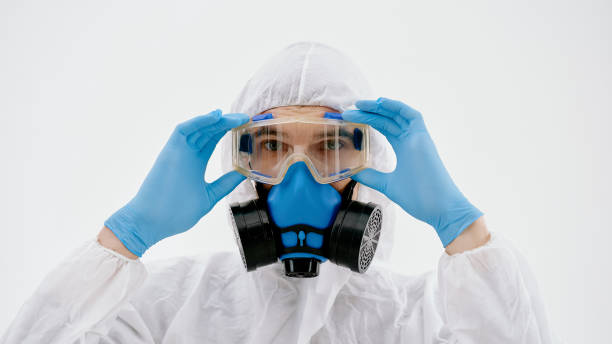 istock professional disinfector, looking at you through safety glasses 1329219699