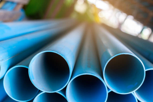 istock Close up to blue plastic pipe background, PVC pipes stacked in warehouse. 1329219926
