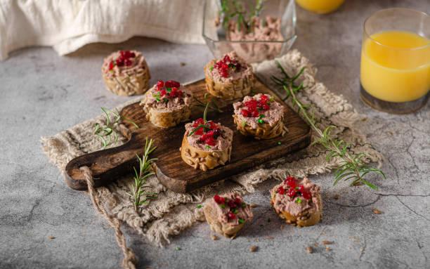 Homemade pate on heathy bread with cranberries Delicious homemade pate with wholegrain pastry and herbs heathy snack stock pictures, royalty-free photos & images