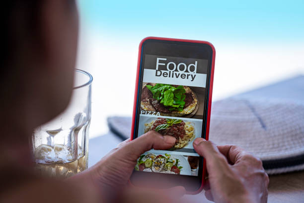 istock Woman using mobile app to order food. 1329221157
