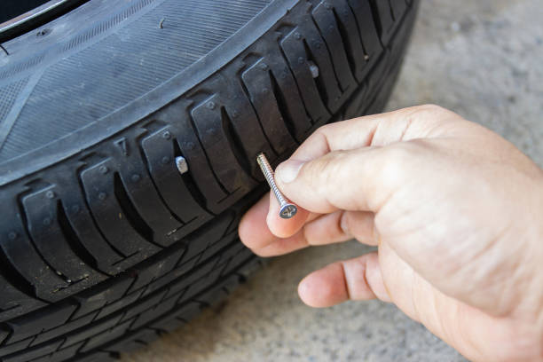 istock Screw in tyre stuck inside it, concept checked and removing 1329222172