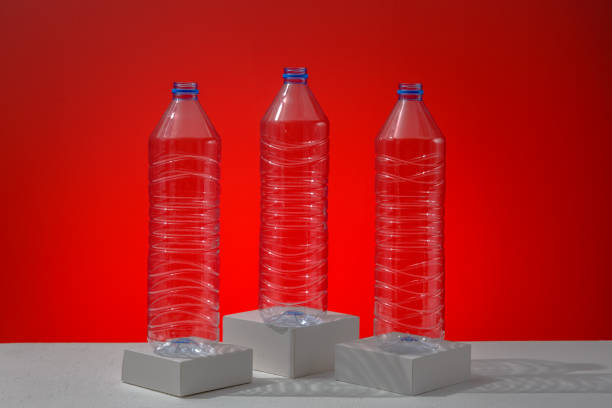 istock Plastic bottles on a red background as a symbol of ecological catastrophes. 1329224433