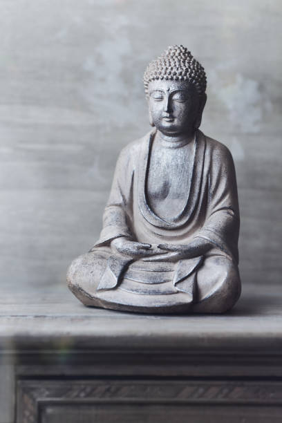 istock Meditating Buddha Statue on wooden background. Copy space. 1329225862